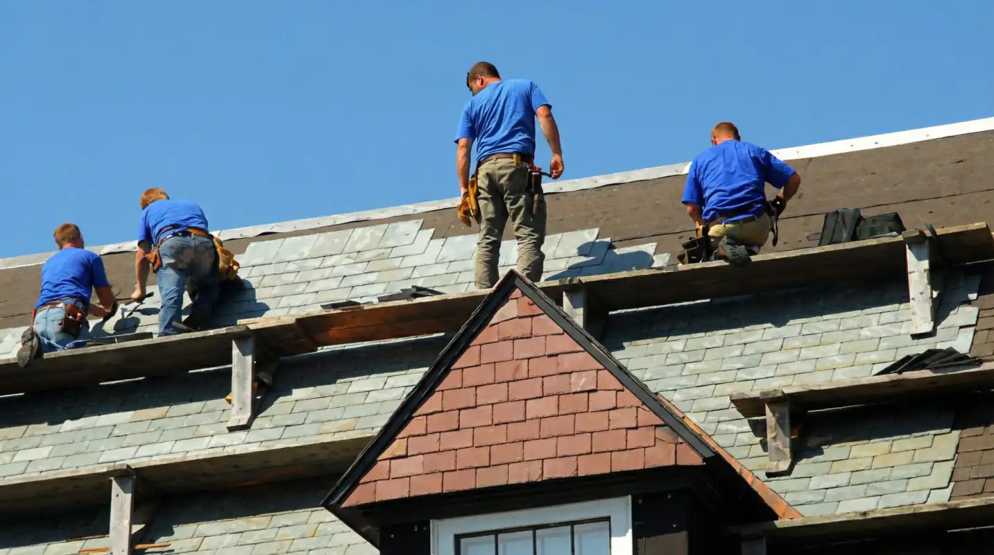 Roof replacement in progress with a team of professional contractors installing new shingles on a residential home in Kansas City, MO