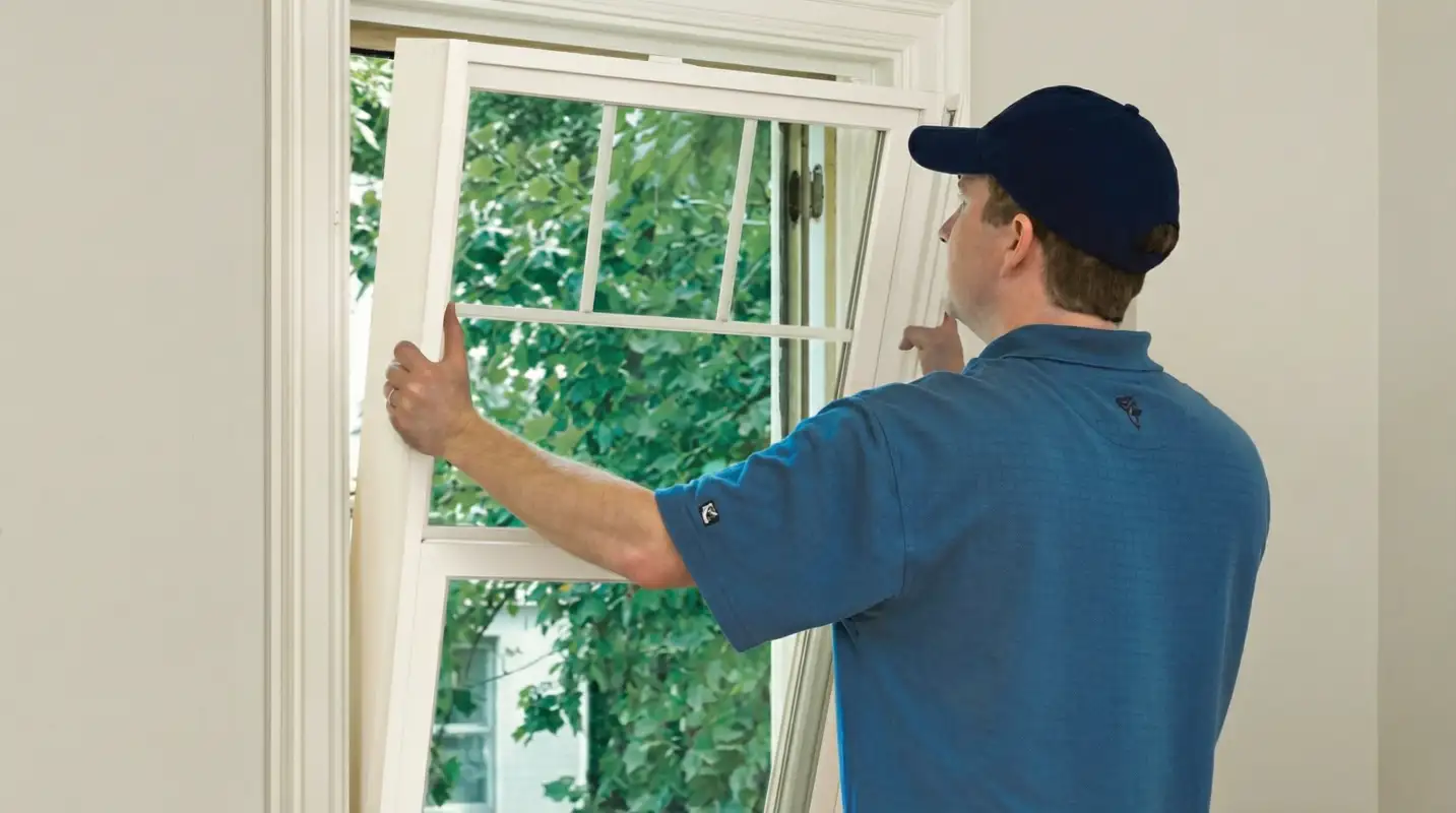 Professional contractors performing a residential window insulation and replacement service in Kansas City, MO